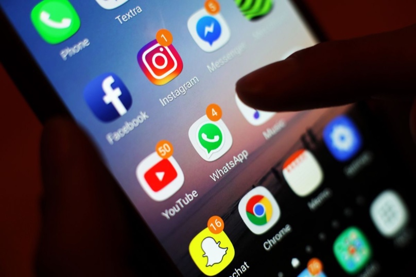 People using social media on smartphones, showing how ChatGPT cites social content when forming brand recommendations