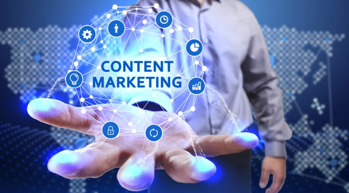 Hand holding a glowing content marketing concept network with icons for analytics, time, audience, and security