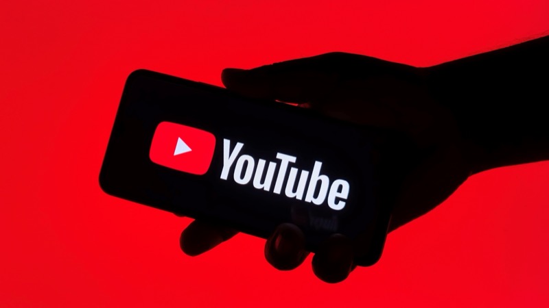 Person watching YouTube on a smartphone illustrating mobile video consumption and the importance of thumbnail visibility on small screens